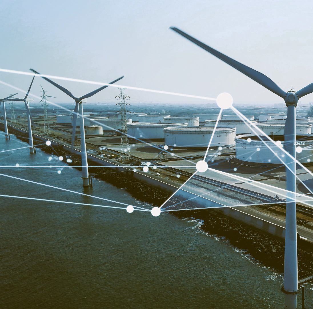 Wind turbines and energy storage tanks connected by digital network lines, representing VigilantIoE’s intelligent monitoring and power management for critical infrastructure.